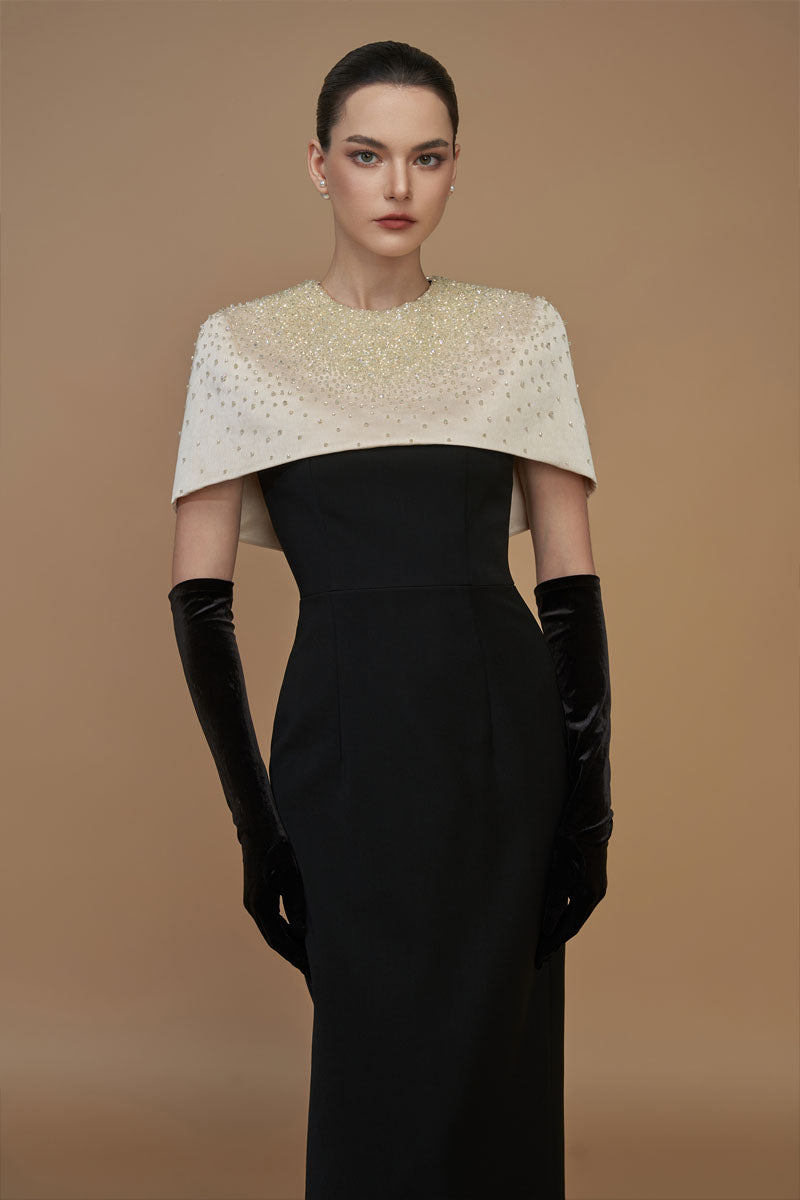 White crepe and silk taffeta cap sleeve gown by I.H.F featuring a round neck, column silhouette, and mini cape detail.