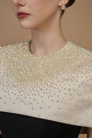 White crepe and silk taffeta cap sleeve gown by I.H.F featuring a round neck and elegant mini cape detail.