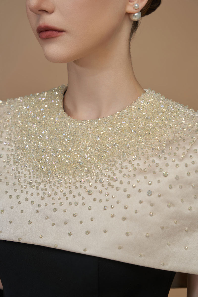 White crepe and silk taffeta cap sleeve gown by I.H.F featuring a round neck and elegant mini cape detail.