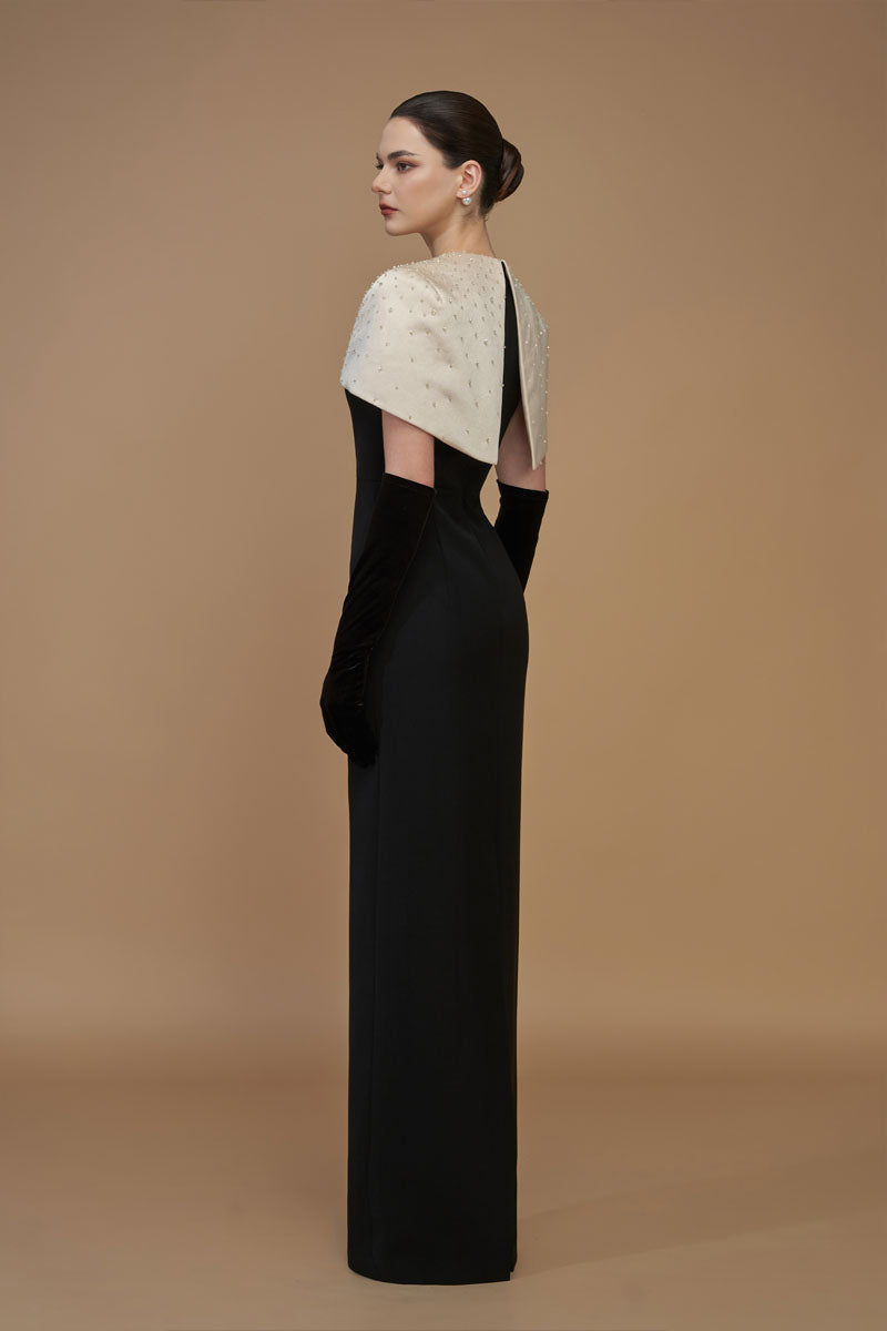 Elegant white crepe and silk taffeta gown with cap sleeves and mini cape, by I.H.F, shown in beige and black tones.