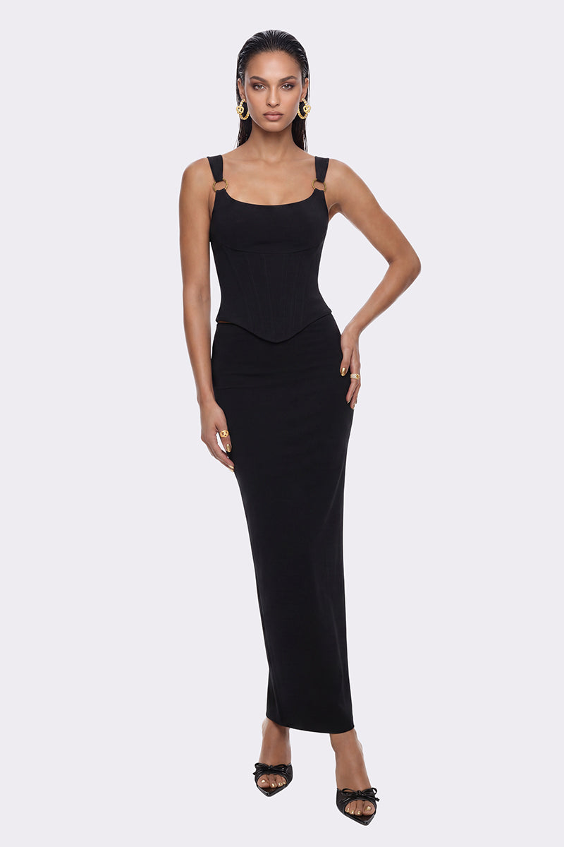Black Roxana corset top by Nana Jacqueline, shown on a model, featuring fitted design and stylish details.