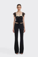 Black ruched mini top from Stolen Stores, featuring fitted design and stylish ruching details, perfect for casual or night-out wear.