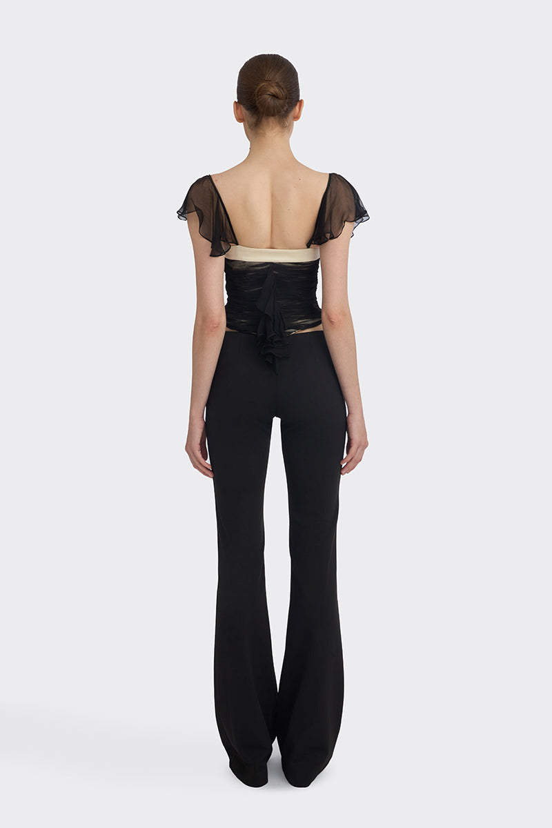 Black ruched mini top by Stolen Stores, featuring a fitted design with gathered fabric and stylish detailing.