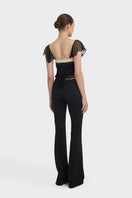 Black ruched mini top from Stolen Stores, featuring fitted design and stylish details, perfect for trendy casual wear.