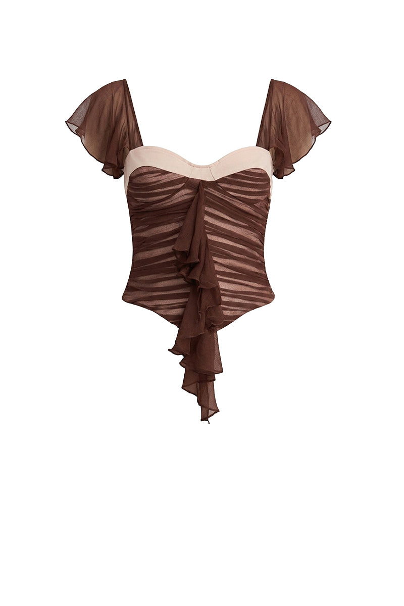 Brown ruched mini top by Stolen Stores, featuring gathered fabric and a fitted style, shown on a model.
