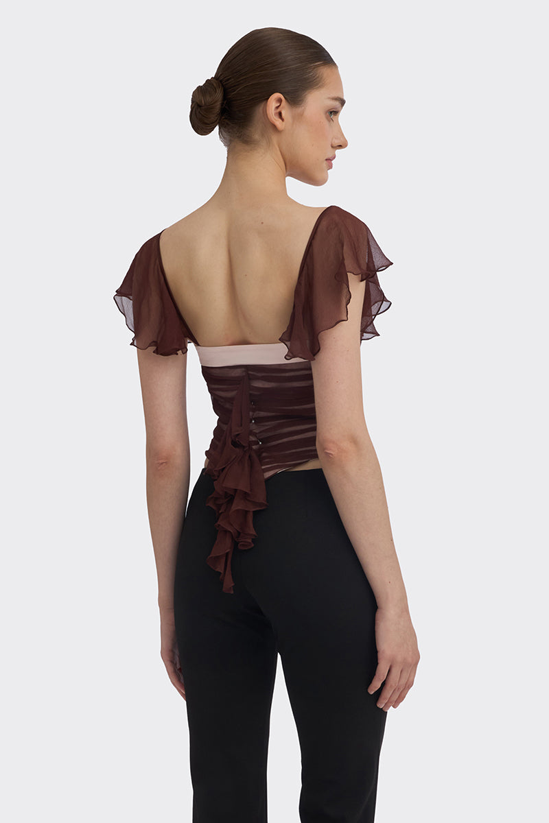 Brown ruched mini top by Stolen Stores, featuring fitted design and gathered fabric detail, styled with long sleeves.