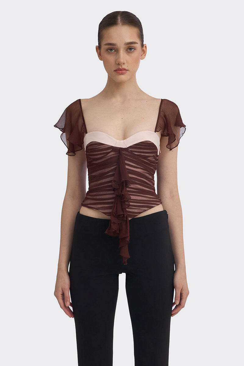 Brown ruched mini top by Stolen Stores, featuring gathered fabric and a stylish fitted design, shown on a model.
