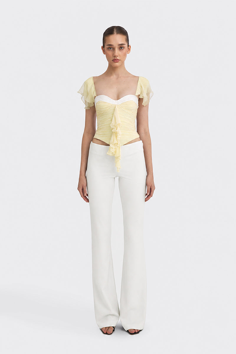 Light yellow CULT MIA X Stolen Stores ruched mini top with fitted design and gathered details, perfect for stylish casual wear.