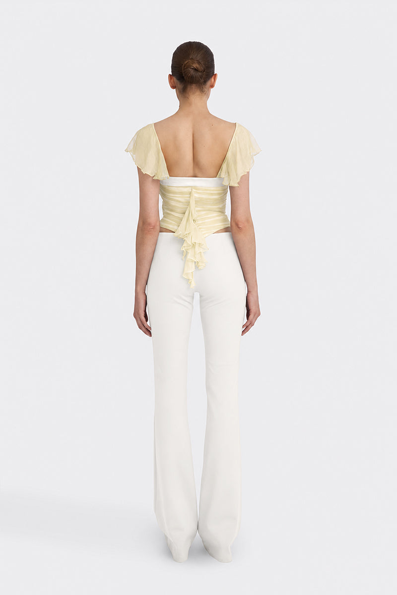 Light yellow ruched mini top by Stolen Stores from the CULT MIA X Stolen Stores collection, shown on a model.