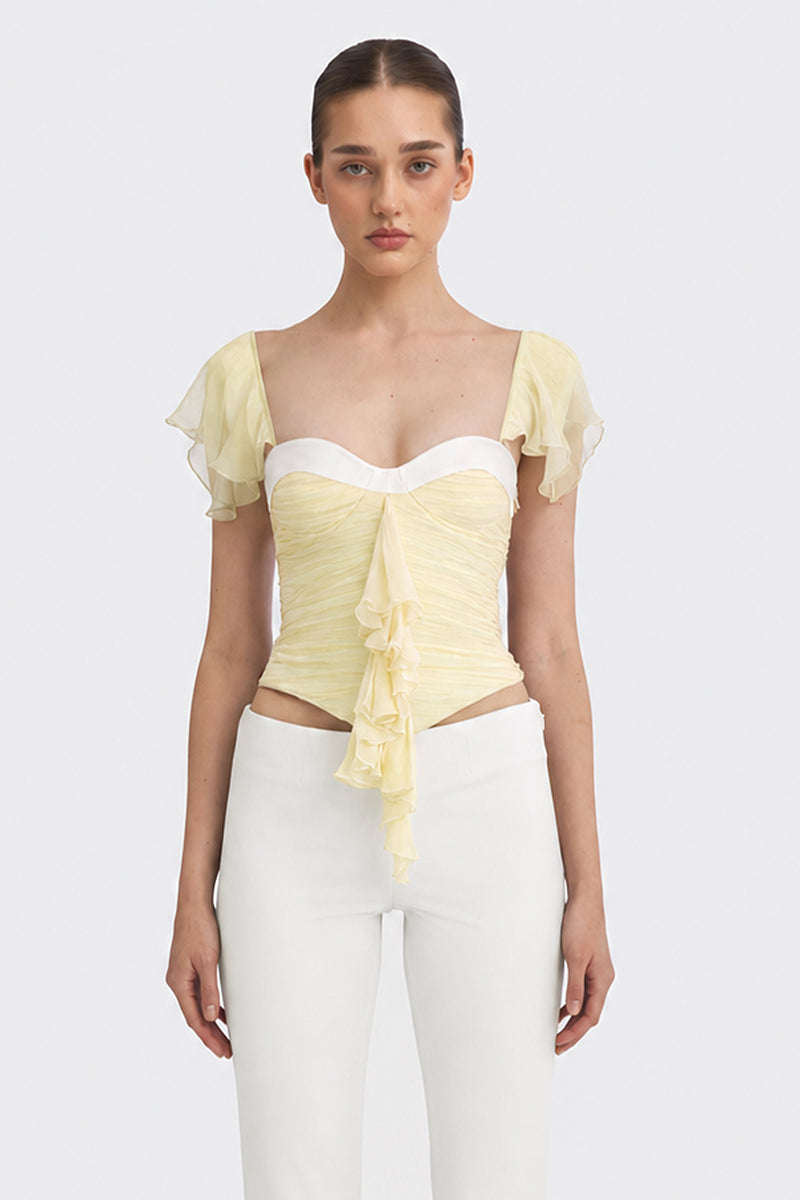 Light yellow ruched mini top by Stolen Stores from the CULT MIA X Stolen Stores collection, featuring fitted design and gathered fabric.