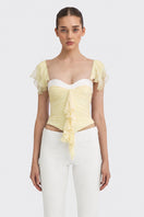 Light yellow ruched mini top by Stolen Stores from the CULT MIA X Stolen Stores collection, featuring fitted design and gathered fabric.