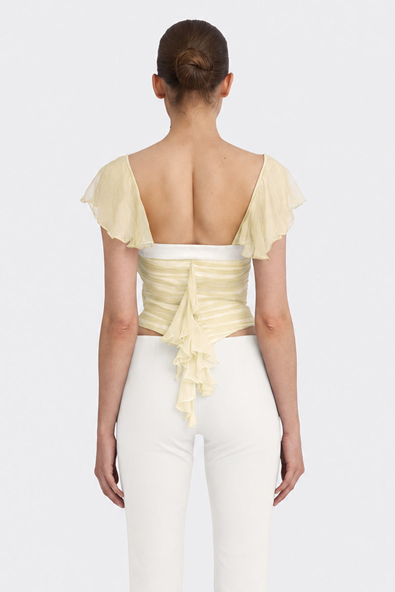 Light yellow ruched mini top by Stolen Stores from the CULT MIA X Stolen Stores collection, shown on a model.