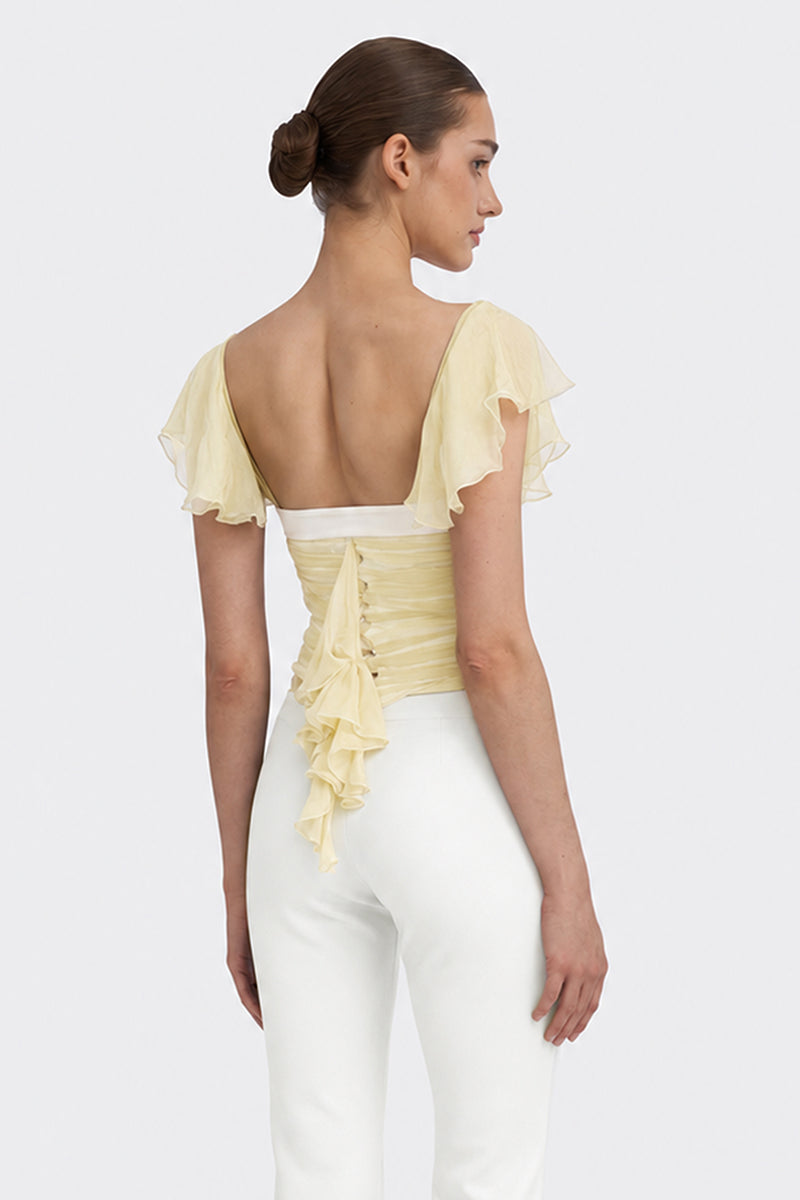 Light yellow ruched mini top by Stolen Stores from the CULT MIA X Stolen Stores collection, featuring a fitted, stylish design.