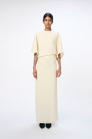 White URA RUNA maxi dress with flowing fabric and elegant design, perfect for summer or special occasions.