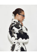 Sayya fur maxi coat in cow print, stylish and warm, featuring a long silhouette and plush texture.