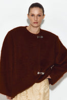 Sayya brown mohair jacket displayed on a hanger, showcasing soft, luxurious fabric and classic jacket style.