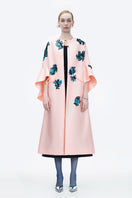 Pink Inner Blossom coat by Tiny Ink, stylish outerwear with a soft, floral-inspired design, displayed on a hanger.