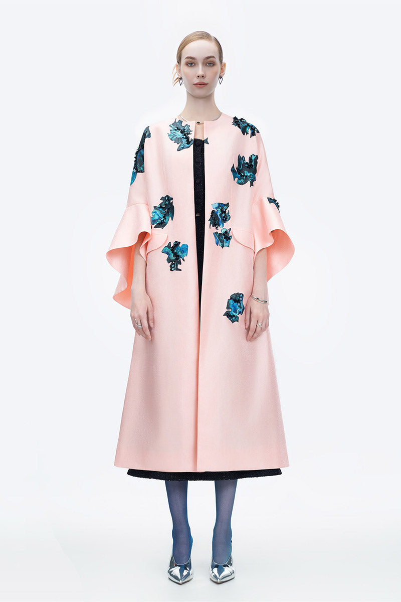 Pink Inner Blossom coat by Tiny Ink, stylish outerwear with a soft, floral-inspired design, displayed on a hanger.