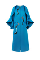Blue Poppy of the Moon coat by Tiny Ink, stylish and cozy outerwear with floral-inspired design, shown on a model.
