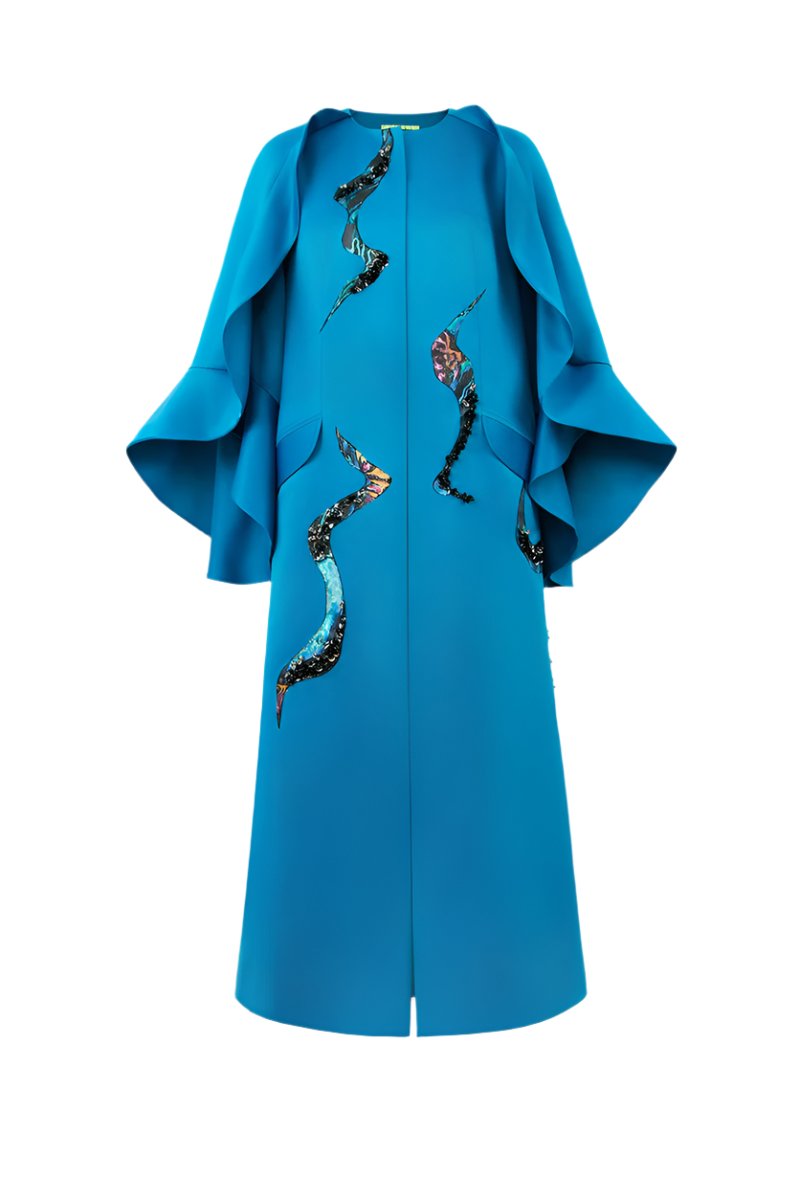 Blue Poppy of the Moon coat by Tiny Ink, stylish and cozy outerwear with floral-inspired design, shown on a model.