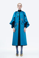 Blue Poppy of the Moon coat by Tiny Ink, stylish outerwear with floral design, displayed on a hanger against a neutral background.