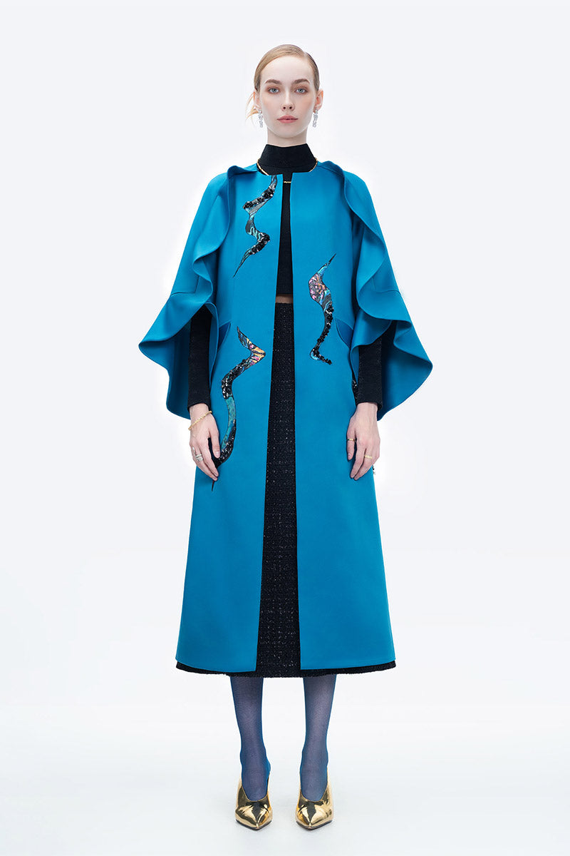 Blue Poppy of the Moon coat by Tiny Ink, stylish outerwear with floral design, displayed on a hanger against a neutral background.