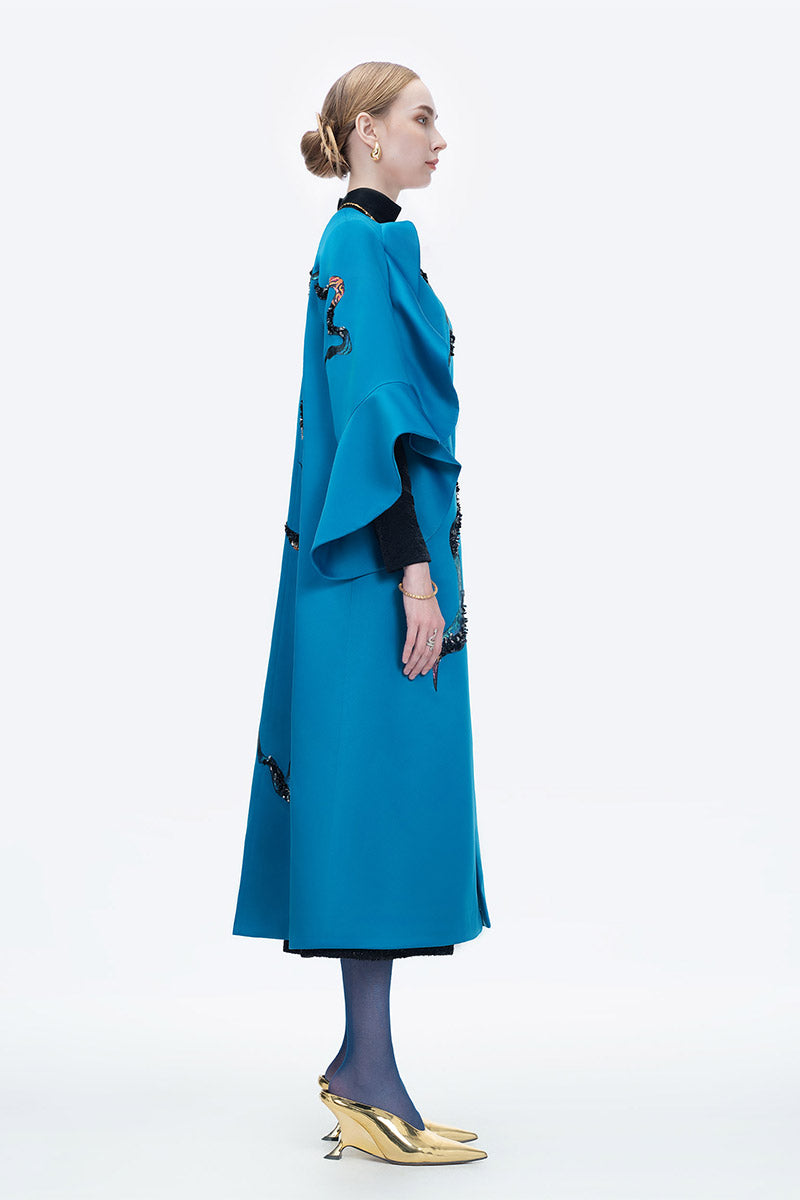 Blue Poppy of the Moon coat by Tiny Ink, a stylish and cozy outerwear piece with floral design details.