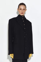 Black wool jacket by Sayya, featuring a tailored fit and classic design, shown on a model with a high collar and button details.