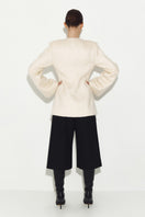White Mohair jacket by Sayya, stylish and cozy outerwear with a soft, textured knit fabric, displayed on a hanger.