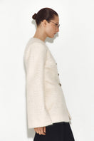 White Mohair jacket by Sayya, stylish and cozy with a soft, textured knit fabric, shown on a model.