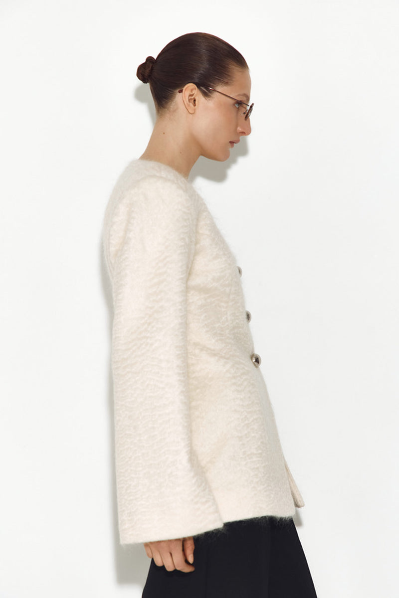 White Mohair jacket by Sayya, stylish and cozy with a soft, textured knit fabric, shown on a model.