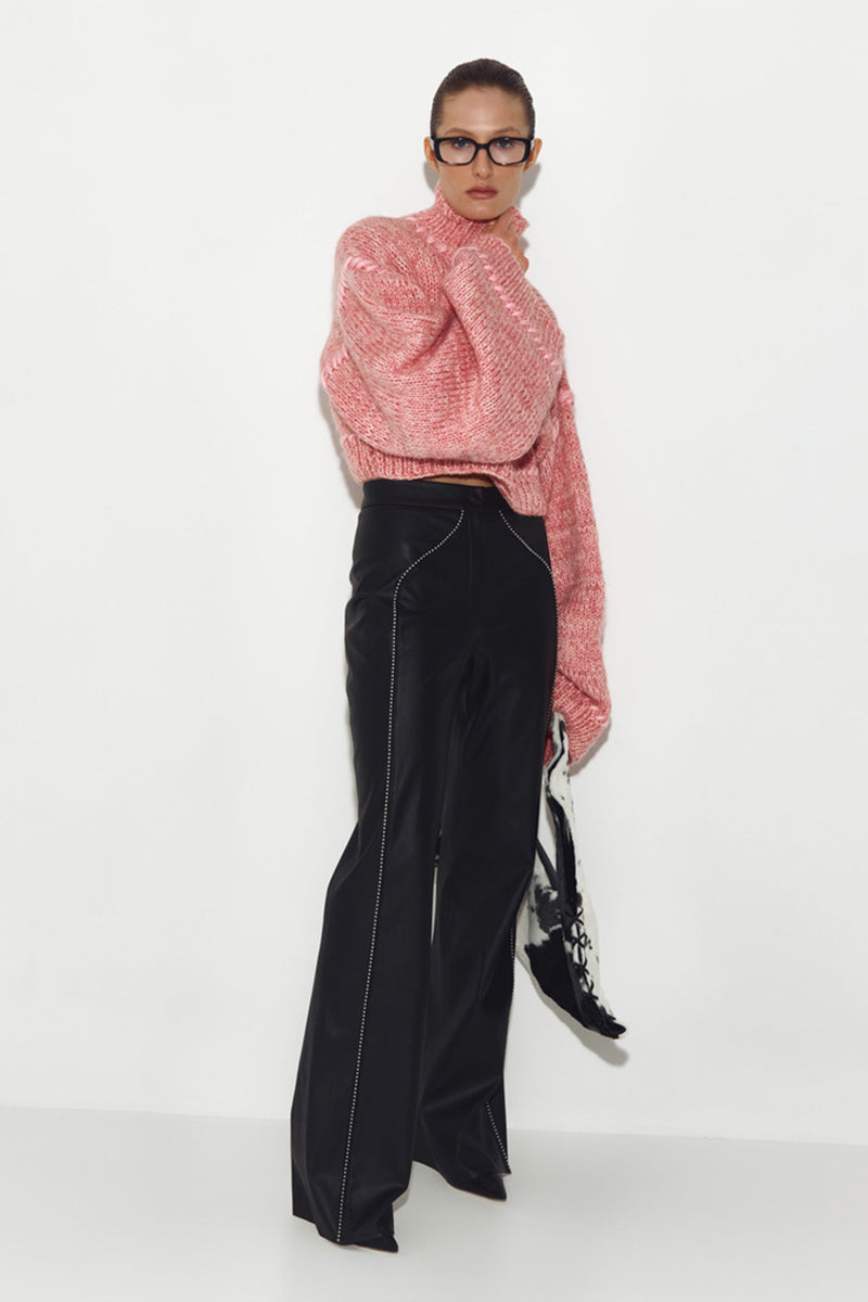Pink Sayya sweater with soft knit fabric and long sleeves, shown on a hanger.
