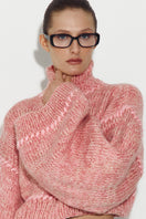 Pink Sayya sweater with long sleeves and cozy knit fabric, displayed flat on a white background.