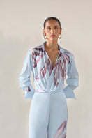 Baby blue Tinta Latina Sabana blouse, stylish women's top with a relaxed fit and soft fabric, shown on a model.