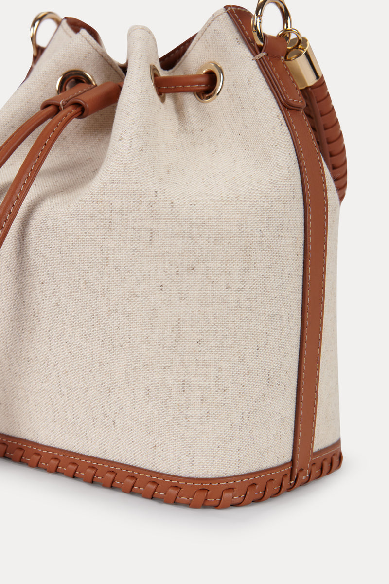 Saonara linen bucket top handle bag with a structured design and natural woven texture, featuring a sturdy top handle.
