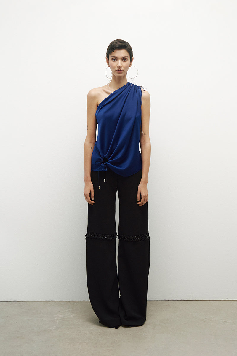 JC Pajares pants with chains, featuring a stylish design and metal chain accents, shown in a close-up image.