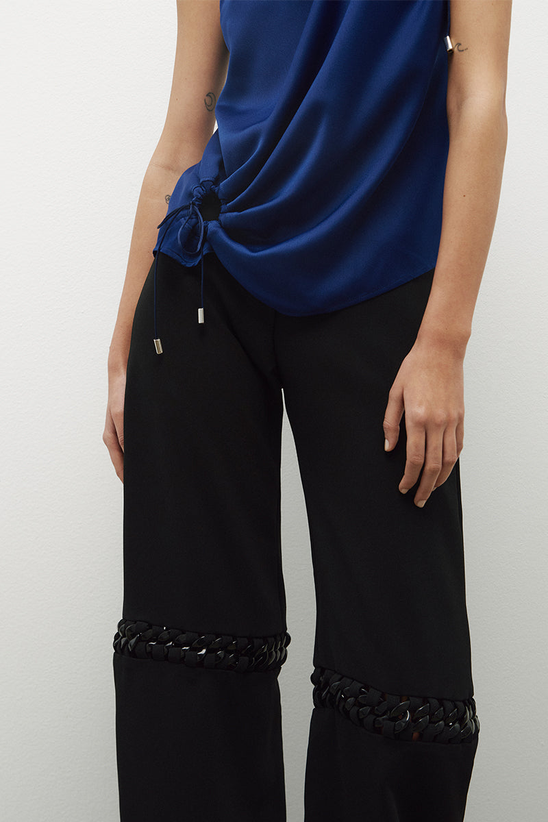 JC Pajares pants with chains, black denim trousers featuring metal chain details and a stylish, edgy design.