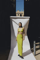 Sayya lime bustier top with fitted design and adjustable straps, shown on a hanger against a plain background.