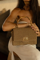 Mara Brazil Serena Bag Lurex top handle bag in shiny metallic fabric with elegant design and structured shape.