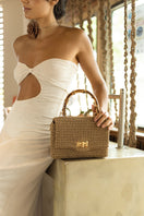 Mara Brazil Serena Bag Lurex top handle bag in gold with metallic finish and structured design.