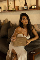 Mara Brazil Serena Bag Lurex top handle bag in gold with shiny metallic finish and elegant design.
