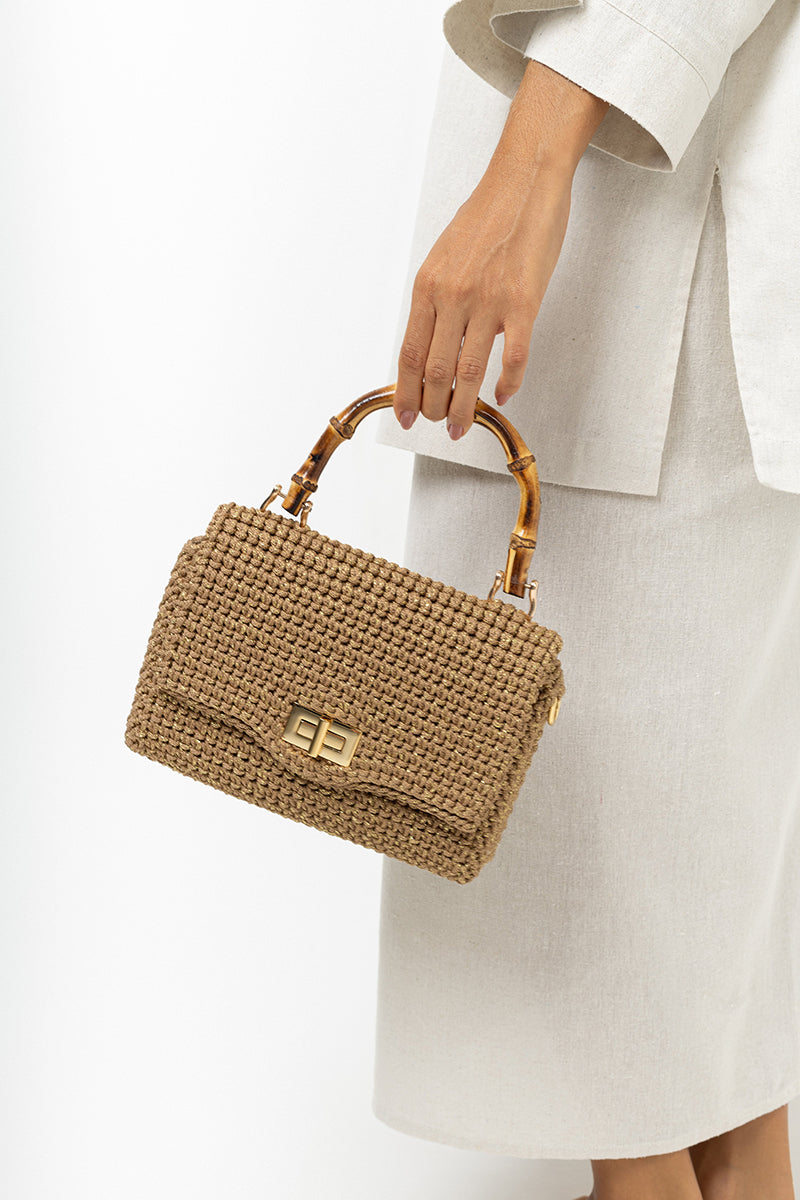 Mara Brazil Serena Bag Lurex top handle bag with metallic gold finish and stylish design, showcasing its elegant handle and textured surface.