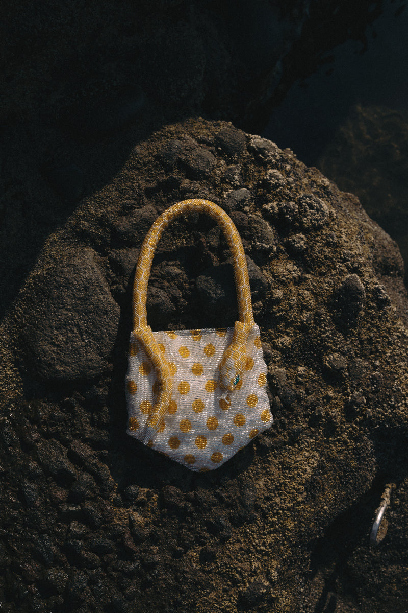 Silver and yellow Serpent Mini shoulder bag by SAC DE SOUL featuring a sleek, curved design and metallic finish.