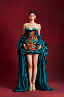 Le Thanh Hoa Azure Phoenix mini dress featuring vibrant blue fabric and intricate floral embroidery.