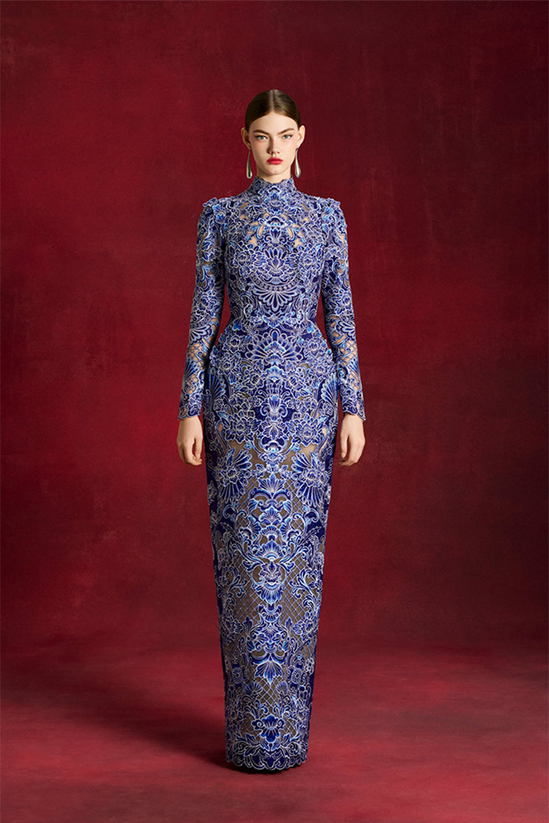 Elegant laser-cut peony gown by Le Thanh Hoa featuring intricate floral detailing and flowing fabric.