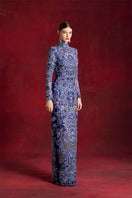 Laser-cut peony gown by Le Thanh Hoa featuring intricate floral lace and elegant flowing fabric for formal occasions.