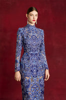 Elegant laser-cut peony gown by Le Thanh Hoa featuring intricate floral embroidery and flowing fabric.