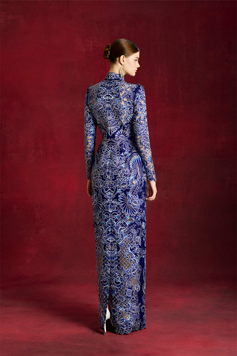 Elegant laser-cut peony gown by Le Thanh Hoa featuring intricate floral details and flowing fabric.