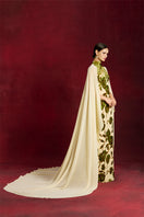 Elegant velvet and floral chiffon gown by Le Thanh Hoa, featuring intricate design and flowing fabric for formal occasions.