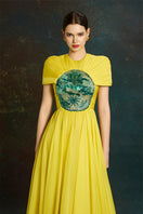 Elegant dragon sun-gown by Le Thanh Hoa featuring intricate embroidery and flowing fabric, perfect for special occasions.